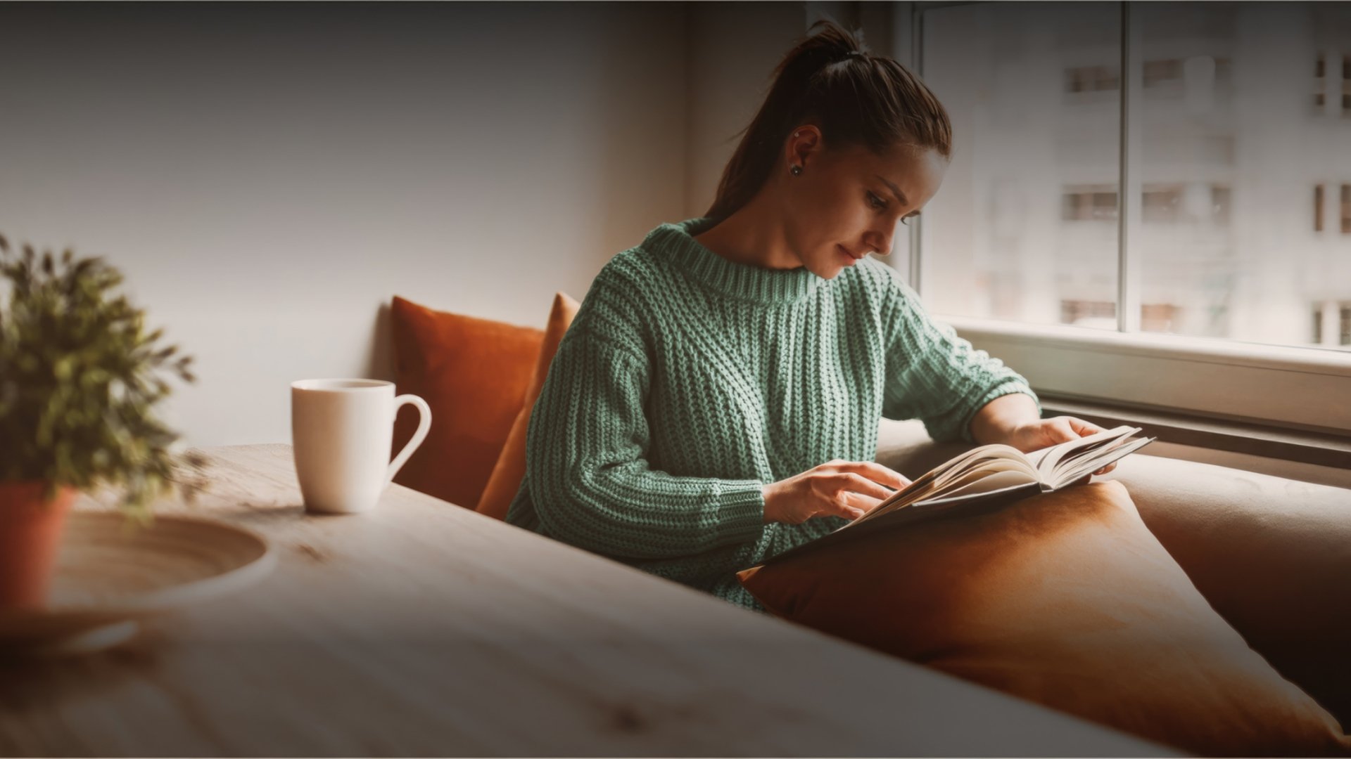 woman at table nook with notebook